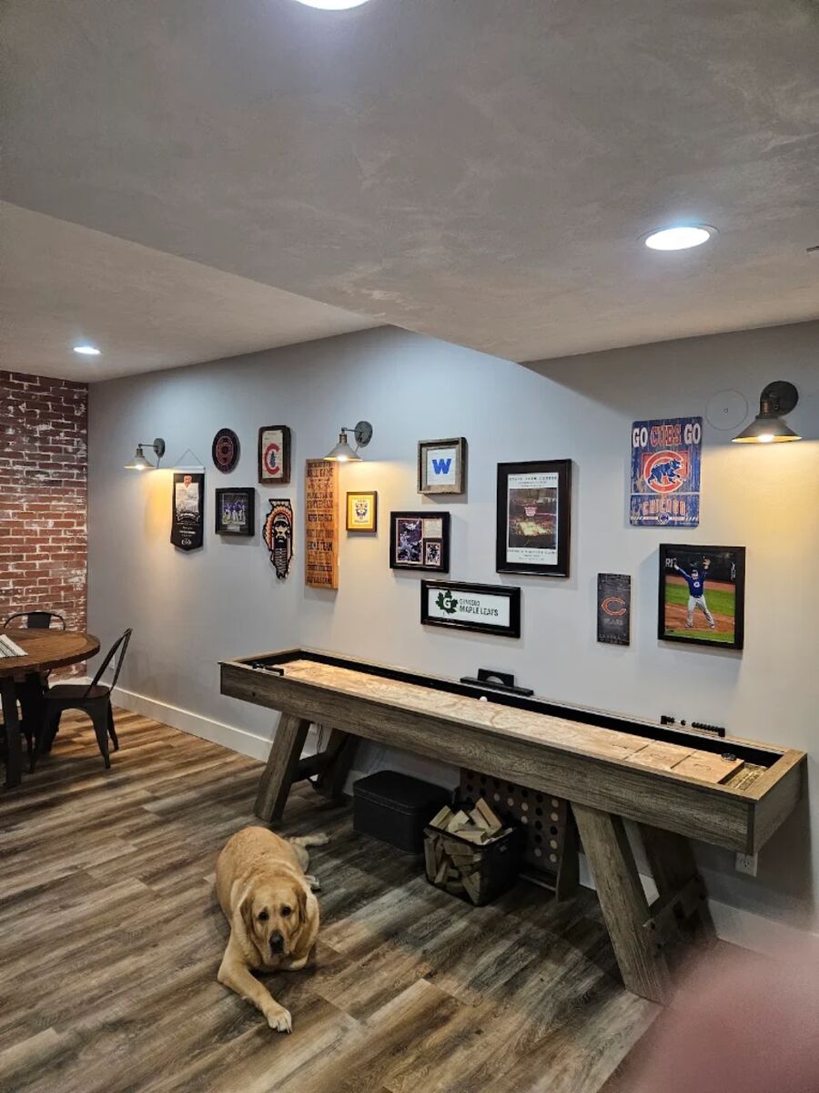 Basement game room with recessed lighting and wall sconces wired by RP Electric
